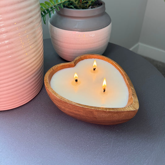 Side view of scented candle on table. Cozy Wood bowl luxury candle.