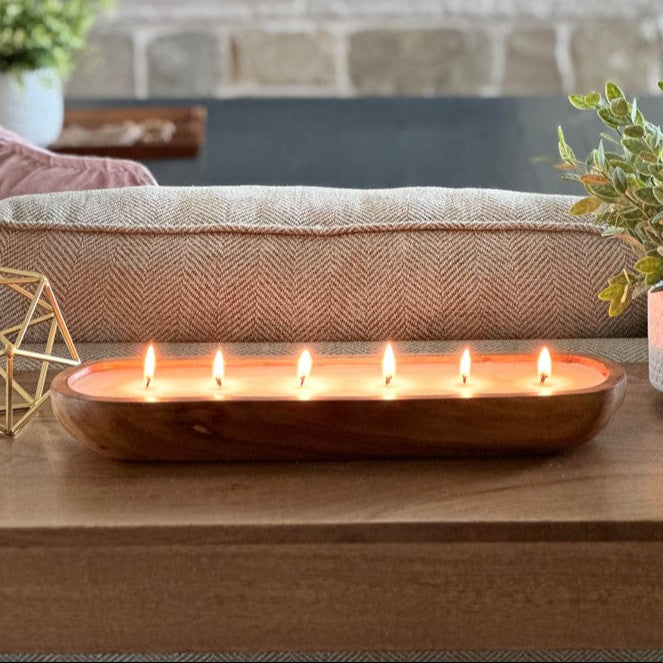 Side view of luxury candle lit in a family room. Lit Scented candle.