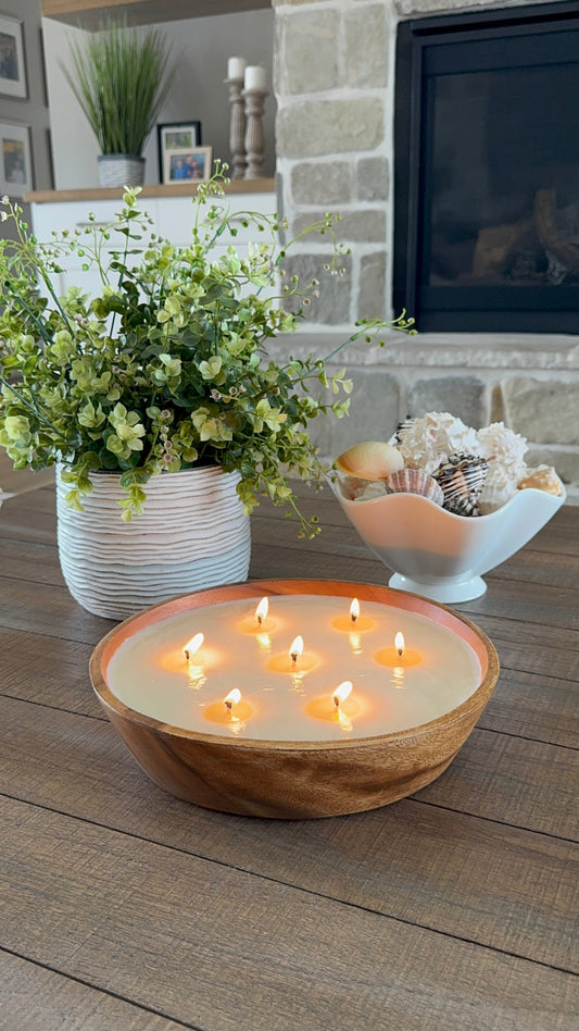side view of 7 wick luxury scented candle in Accacia wood bowl.  