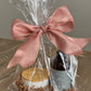 Luxury Candle Gift Set on table.  Includes Scented Candle and Air Freshener Room Spray wrapped in gift bag. 